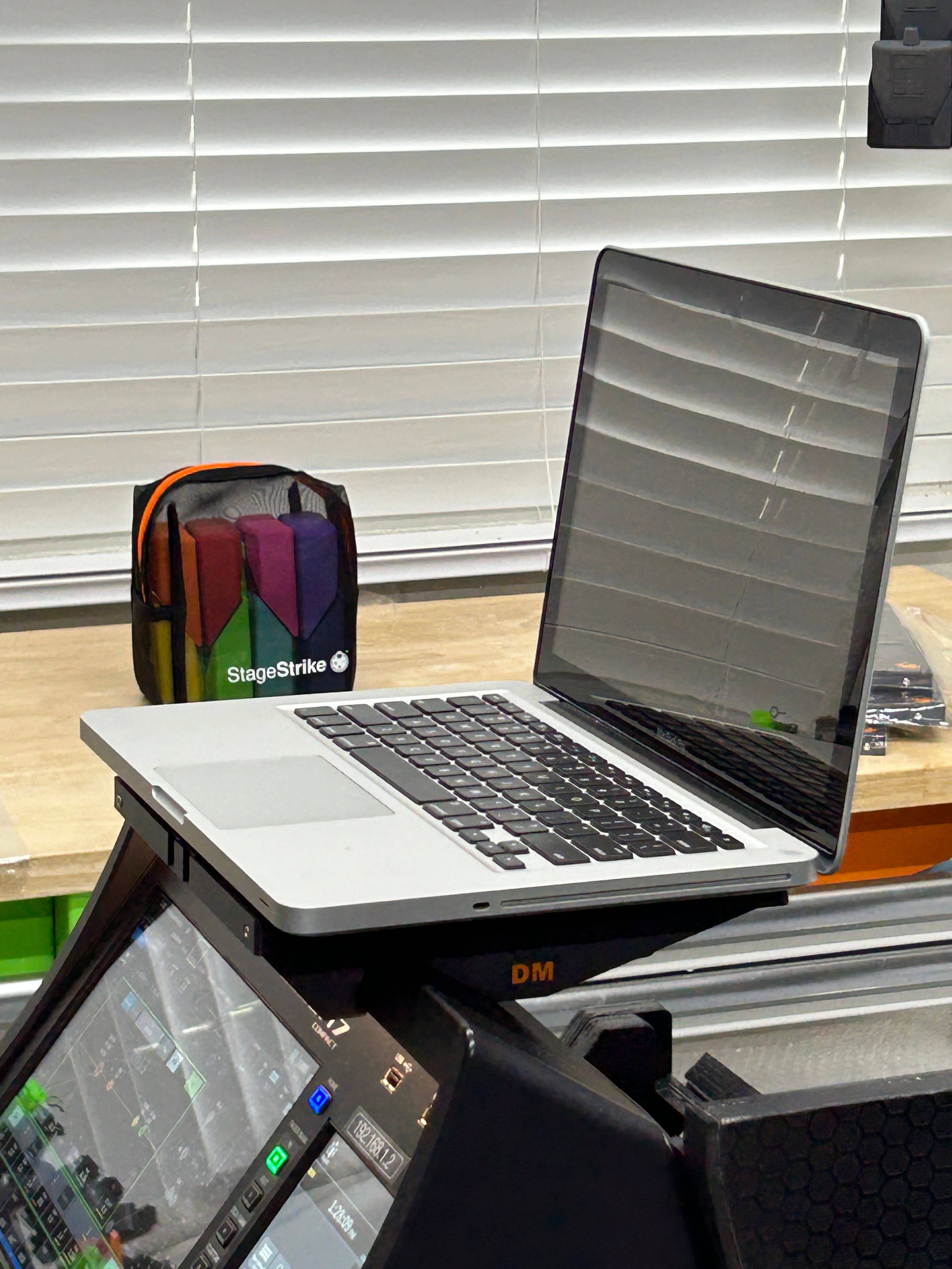 MacBook sitting on top of a StageStrike digiTop mounted on a Yamaha DM7 Compact digital audio console