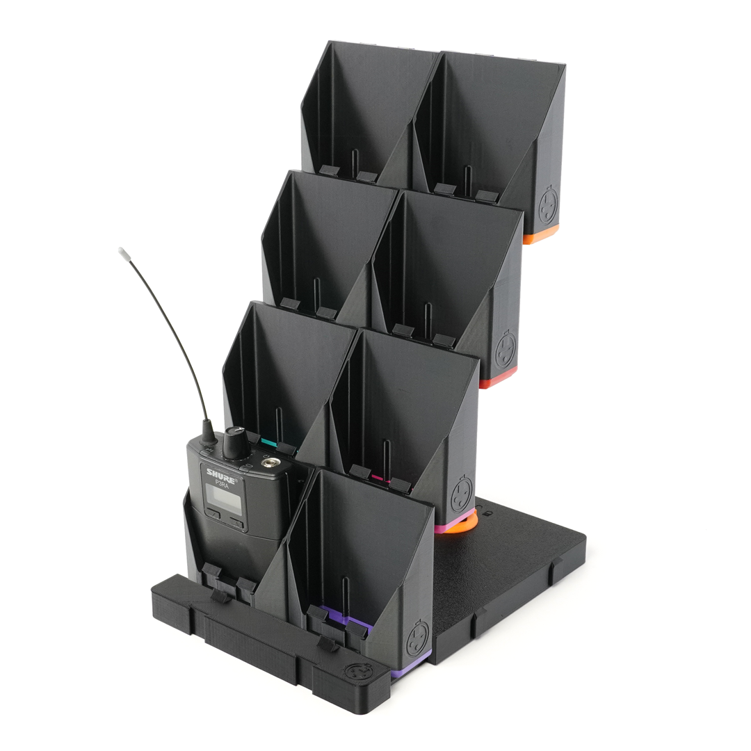 packBase loaded with wireless bodypack transmitters — touring tech table organization