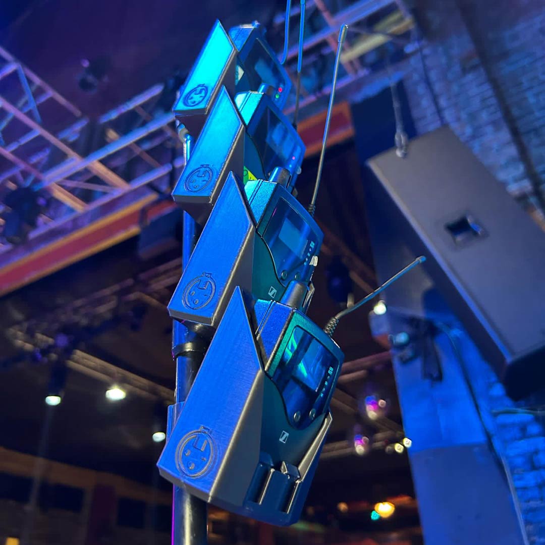 packHolder(4) in use at a live show with Sennheiser wireless bodypacks